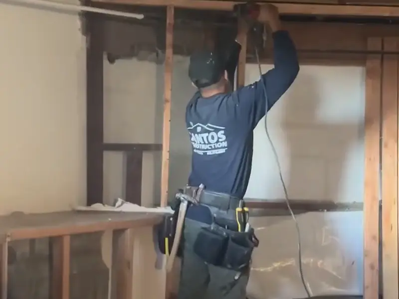 Santos worker removing old cabinets during an interior remodel